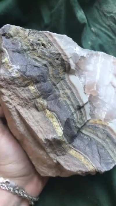 A pyrite vein with some calcite crystals attached. Found in an old quarry!