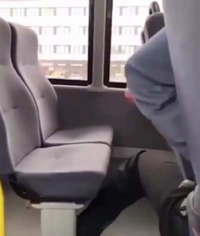 Guy lights up cigarette on public bus