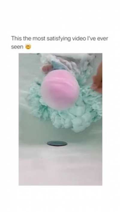 Color-filled balloons popping underwater.