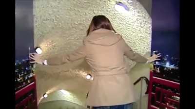 Asian reporter going down slide