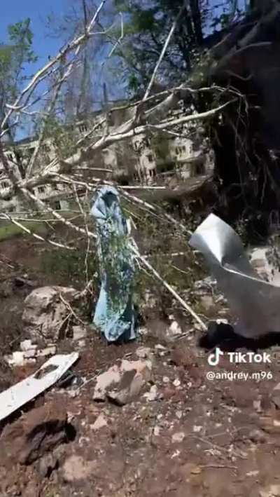 ua pov: Ukrainian soldiers walking the streets in Bakhmut, sounds of combat between the Ukrainian and Russian armies can be heard in the background.