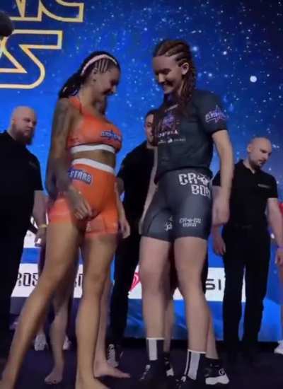 Fighters kiss during their face-off.