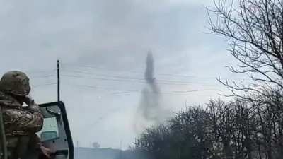 Ukrainian soldiers in a Roshel Senator APC watch as a Ukrainian Mi-24P fires rockets and pops flares. December 2022.