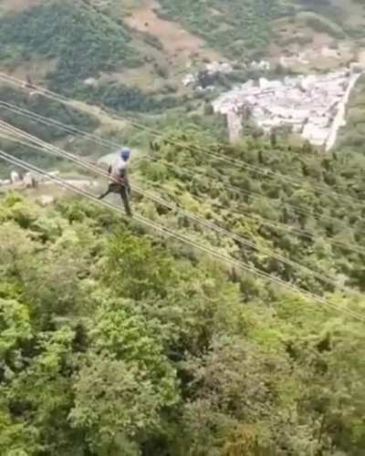 Electric Worker sliding on Ultra-High Voltage Power Line
