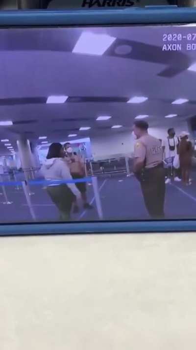 Miami-Dade police officer displays his displeasure after a woman gets too close to him at the airport