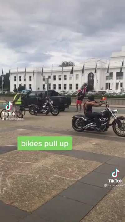 Aussie guy in MAGA hat, bikies not having it.