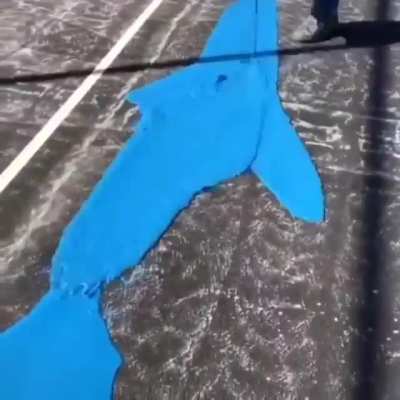 Painting a tennis court.