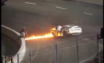Dad rushes onto track to save his son from burning racecar