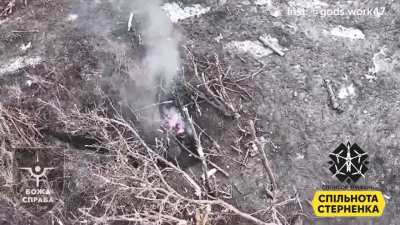 Two Russian soldiers in an embrace, are hit by drop dropped grenade