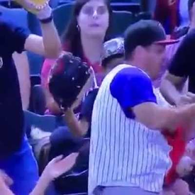 This guy let go of the baby momentarily to catch the ball then saved the baby and barely spilled a drop