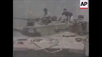 A good example of why a tank shouldn't be left w/o infantry support in an urban area. Here's an Israeli Merkava MBT having her combat capabilities hindered by 2 civilians.