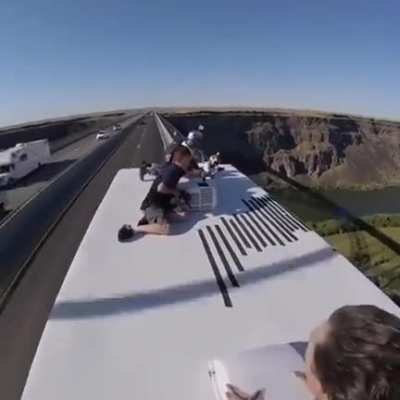 Parachuting off a truck driving over bridge