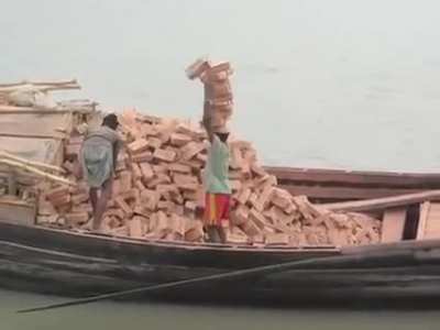 Workers in Bangladesh carrying bricks on their head.