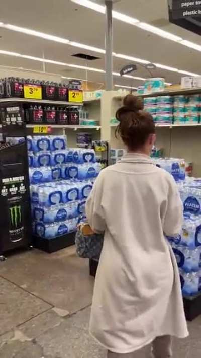 Narsty woman spitting in and resealing chips at supermarket