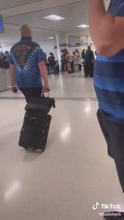 A man who is taking pictures of women in the airport is confronted. The woman forces him to pull out the camera and delete the photos.