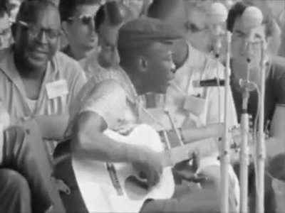John Lee Hooker is performing &ldquo;Boom Boom&rdquo; at the Newport Folk Festival in 1963