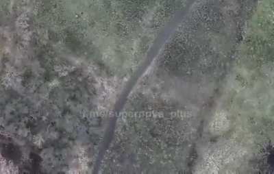 ua pov - drone finds two camouflaged RU soldiers in the grass
