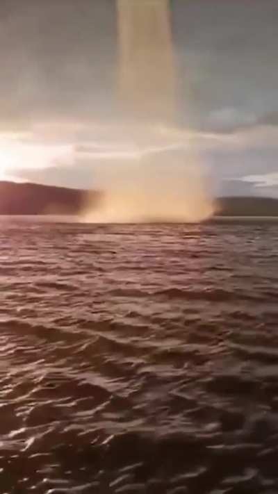 up-close to a curved water spout in the kama river in russia