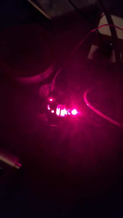 My proper non-diode killing testing rig, you see the optical path from top left (diode) through to the lenses that would read/write the disc, first in red (DVD) and then IR (CD) at 125 mA (way fainter, but that's only the IR filter of my smartphone cam)