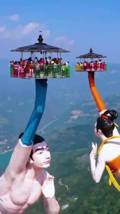 &lsquo;Flying Kiss Ride&rsquo; in China is made of two giant statues, overlooking a 3,000 ft. cliff