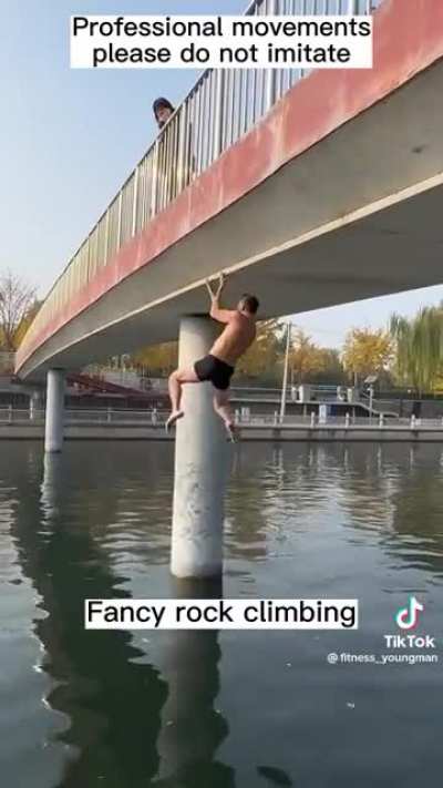 Man climbs bridge with his fingers