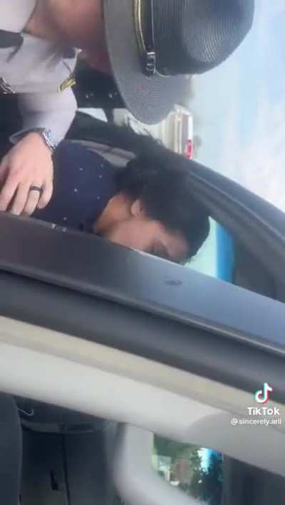 To use her phone while her mom is being pulled over