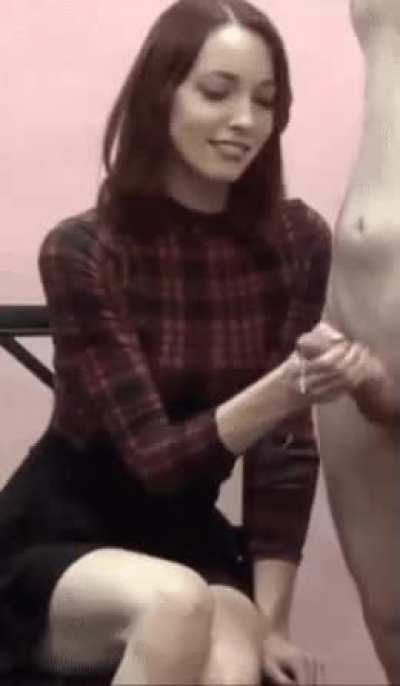 Pretty dressed woman giving a handjob