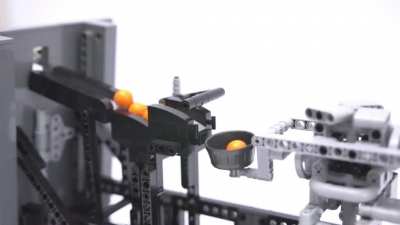 I made a Lego machine that puts balls into buckets.
