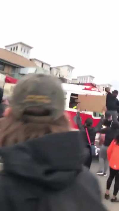 Firetruck on it's way to put out a fire is impeded by protesters