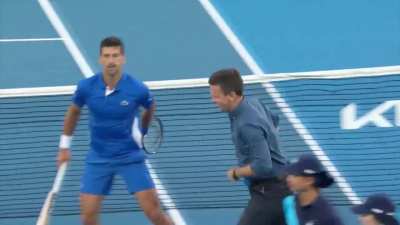 Novak Djokovic playing cricket on the Tennis court.