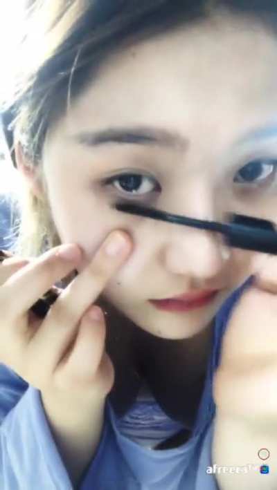 Doing her eyelashes