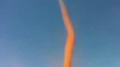 The interesting color of this large dust devil!