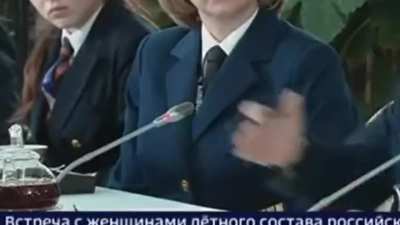 Putin's hand doing something weird at his "meeting with flight attendants"