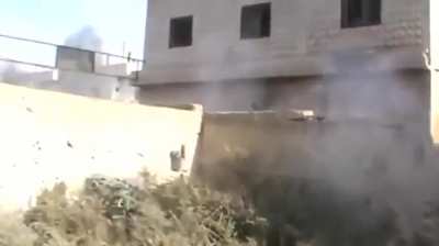 FSA fighter with a close ranged RPG ambush on passing Syrian Army armor - al-Hirak - 11/18/2012