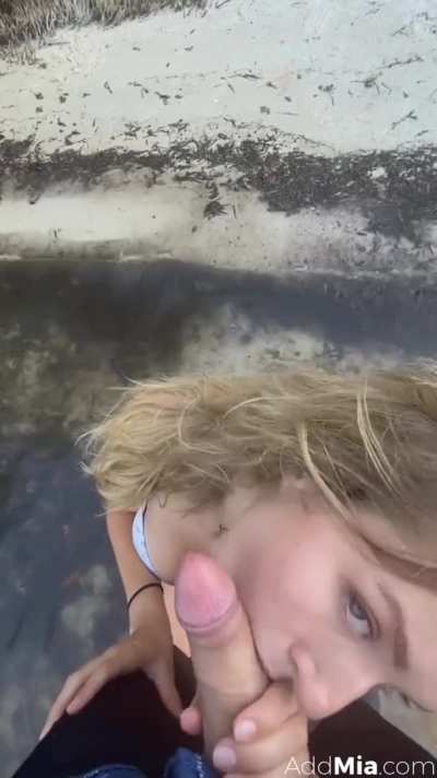 Mia Melano gives blowjob on a beach