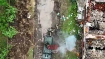 Russian drone grenade drop on Ukrainian soldiers next to a Ukrainian Kozak APC
