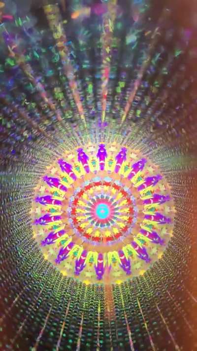 Handmade stained glass kaleidoscope in natural light.
