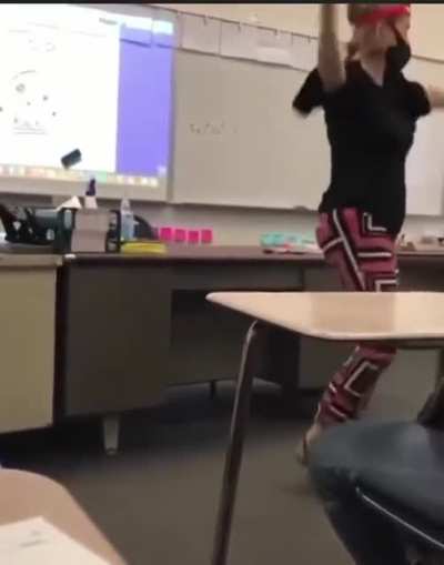 High school teacher performs dance in Native American headdress