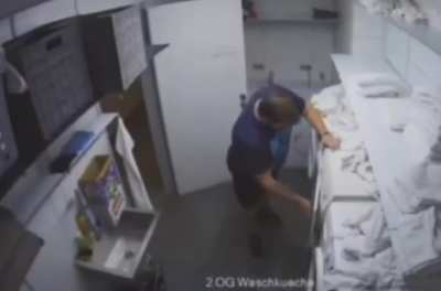 Man struggling against a dryer for dominion over his soul.