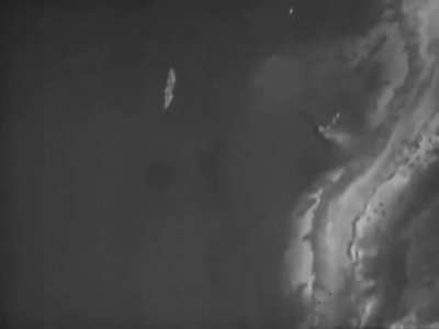 US Navy fighter dives with a crippled IJN A6M Zero off Truk in 1944