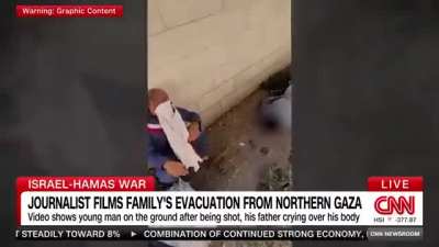 News Scene: A Palestinian father in Gaza follows IDF instructions and leaves his home holding a white flag. His son, who’s coming with him, is shot in the head by the Israeli forces.