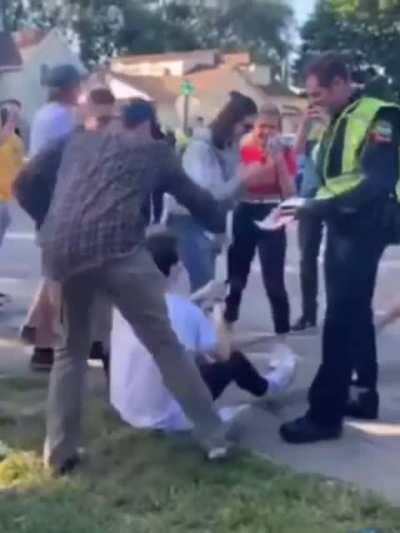 Cop starts to give the guy a drinking ticket, so everybody starts giving him money to pay it off