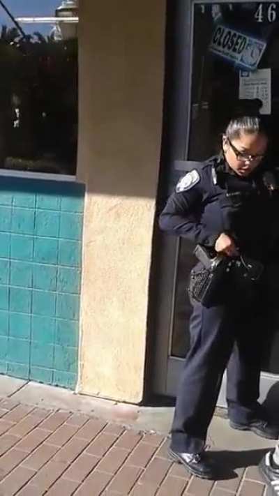 Guy getting arrested for riding his bike on the sidewalk.
