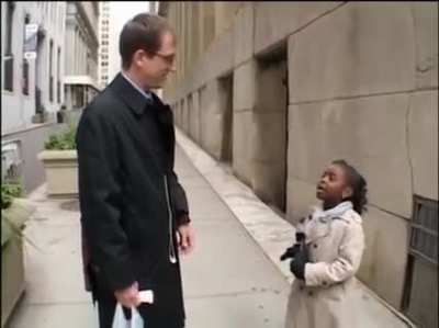 Young reporter asks probing questions while on Wall Street, Questions such as: "Who did you exploit today?"