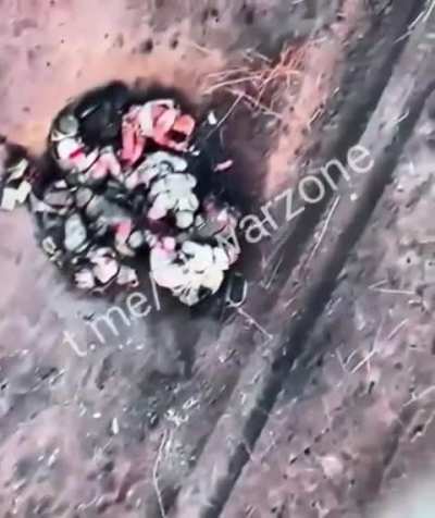Ua drone drops bomb amids burning vehicles and dead russians.