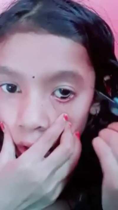 Applying eyeliner