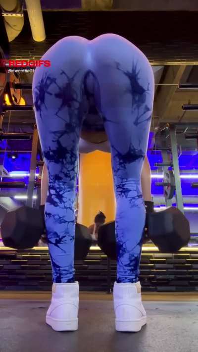 Leaning forward with a hint of tease behind