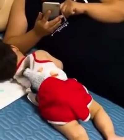 Baby being put to sleep with a flopping salmon