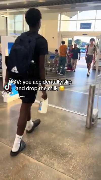 People's "accidentally" spill milk by the entrance of a Walmart 