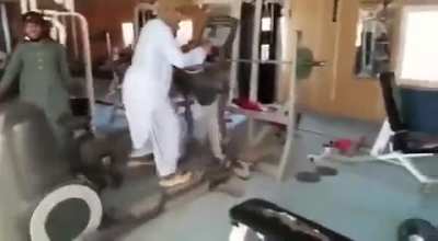 Taliban fighters discover a gym for the first time on an American base